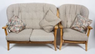 An Ercol pale beech 'Windsor' two seater sofa and an armchair,