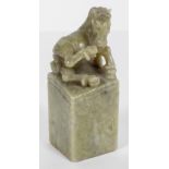 A Chinese green hard stone seal with a horse finial,