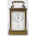 A French brass carriage clock, the enamelled dial with Roman numerals and subsidiary alarm dial,