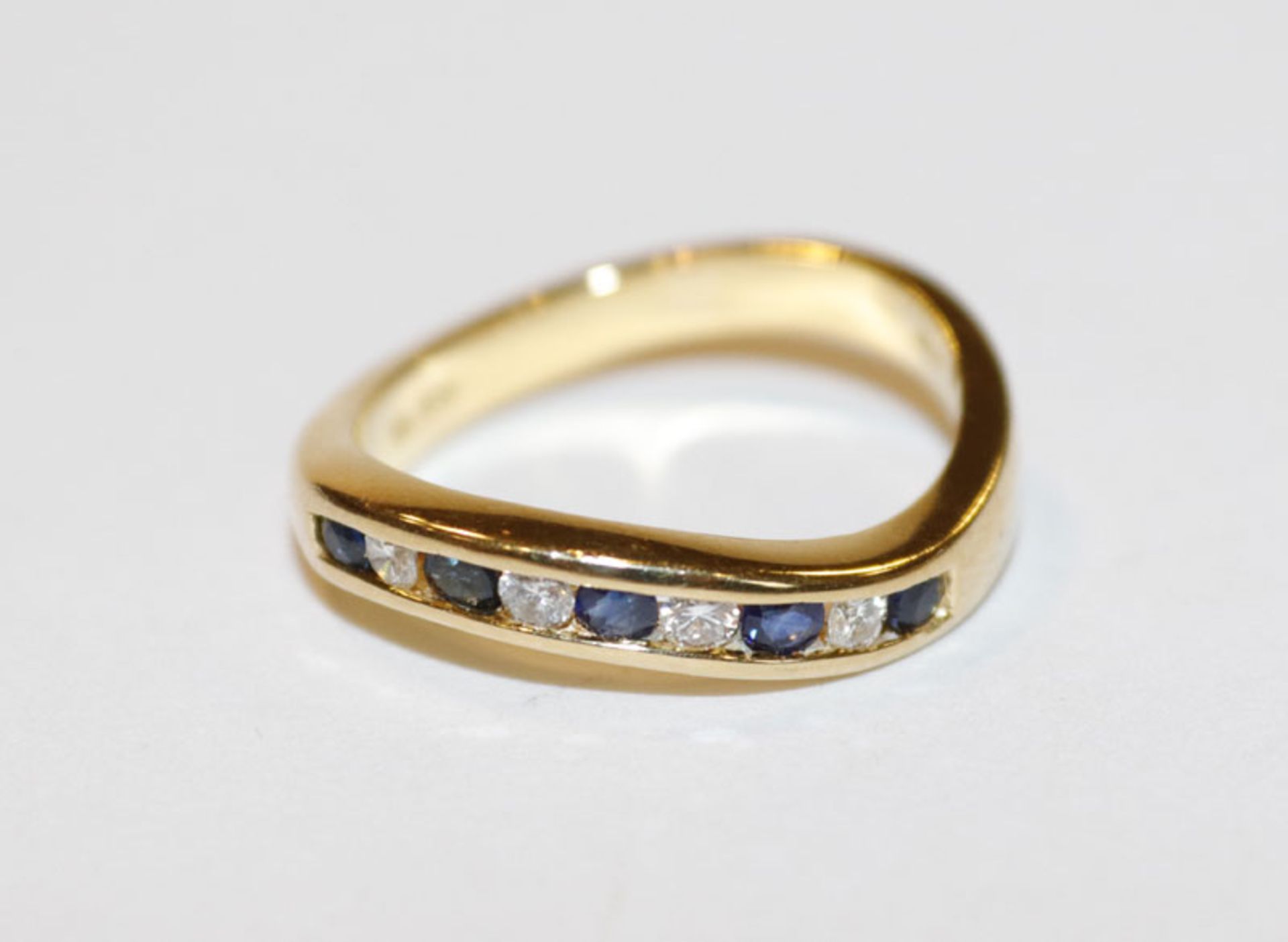18 k Gelbgold Ring in geschwungener Form mit 4 Diamanten und 5 Safiren, Gr. 54