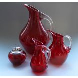 Three Whitefriars ruby glass beaked jugs with celery handles, 1960-80, pattern no. 9649.