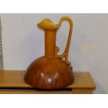 A Bretby Art Pottery treacle glazed jug in Christopher Dresser style, 12" high - rim a/f.