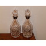 A pair of modern cut glass decanters with Birmingham silver mounts.