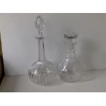A cut glass mallet shaped decanter with stopper.