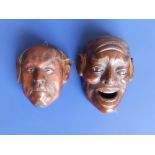 Two Japanese Meiji period lacquered noh masks, each with remnants of hair and inlaid eye details,