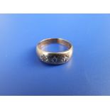 A three stone gypsy set diamond ring - Birmingham marks. Finger size K.