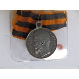 A WWI Imperial Russian Bravery Medal with ribbon - No 1029043 - '3A 4CTEII'.