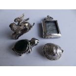 Two miniature silver tortoises, a damaged miniature silver photo frame and a .800 winged lion, 2"