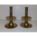 A pair of Charles II brass trumpet based candlesticks, each with a single knop above a wide drip
