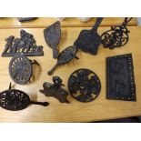 10 Victorian pieces of cast iron fireplace accessories, including kettle stands.