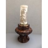 A Japanes Meiji period ivory tusk vase by Onizawa, the sides decorated in relief with some