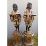 A pair of late 19th/early 20thC Italian giltwood blackamoor figural stands, each young male figure