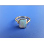 A rectangular opal solitaire ring set in 18ct gold. Finger size N.