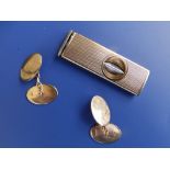 A pair of 9ct gold oval cufflinks and a cigar cutter. (3)