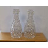 A pair of triple ring cut glass decanters.