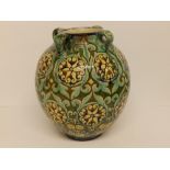 A Della Robbia Pottery four-handled vase decorated with floral roundels and smaller flowers with