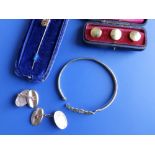 A pair of oval 9ct cufflinks, a 9ct bangle, a stick pin and three 18ct studs. (8)