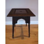 An Eastern carved rosewood square top occasional table with overall foliate decoration, the