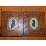 A pair of 19thC silhouette portraits with gold painted highlights.
