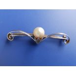 A pearl & diamond set yellow metal bar brooch of scroll form, 2".