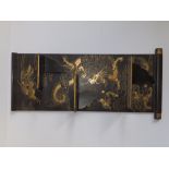 A Japanese folding gilt black lacquered wall rack decorated with dragon & phoenix, 22" high.