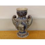 A 19thC German stoneware vase with eagle head handles, 7.75" high.