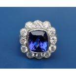 A tanzanite & diamond cluster ring, the central cushion/mixed cut tanzanite weighing approximately