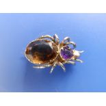 A citrine & amethyst set yellow metal spider brooch, 1" across.