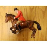 A Beswick huntsman on horse wall plaque - one ear chipped.