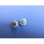 A pair of emerald & diamond cluster stud earrins.