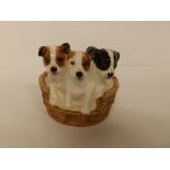 A small Royal Doulton group - three puppies in a basket - HN2588, 3" across.