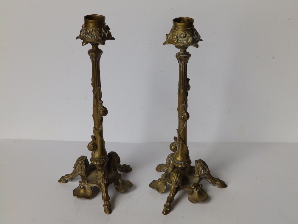 A pair of art nouveau gilt brass candlesticks, each decorated with three snails ascending the