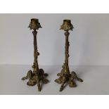 A pair of art nouveau gilt brass candlesticks, each decorated with three snails ascending the