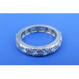 A diamond set white metal eternity ring having 14 brilliant cut stones of total weight approximately