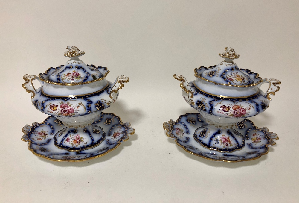 A pair of Victorian sauce tureens & covers on stands in the rococo taste, (6)