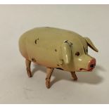 A 1940's Japanese clockwork tinplate 'Walking Pig' with original box and key.