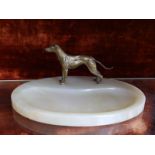 An oval green onyx desk stand mounted with a small gilt brass study of a dog, 10" across base,