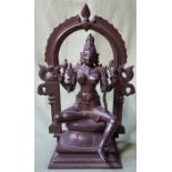 An antique Indian bronze sectional figure depicting a seated female deity beneath an arch, 12"