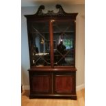 An Edwardian mahogany two-stage bookcase in Edwards & Roberts style, the open-fret swan neck