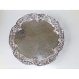 A Victorian silver plated circular salver with openwork grapevine border.