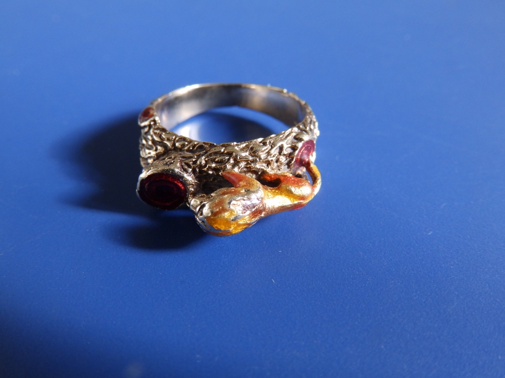 A '14' yellow metal ring modelled with a lion gazing into a red enamelled pool. Finger size N. - Image 2 of 4