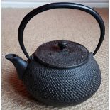 An antique Japanese cast iron teapot with seal mark.
