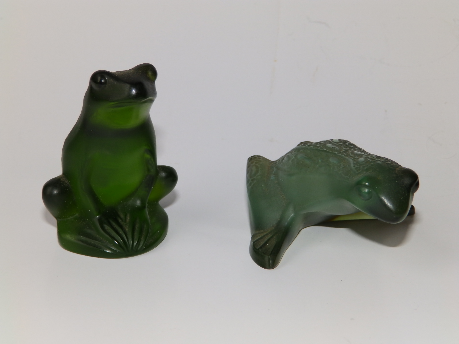 Two small Lalique green glass frogs, 2.5" across and 2" high.