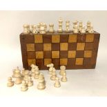 A late 19th/early 20thC ivory chess set with folding games box.