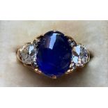 A Victorian certified Sri-Lankan cabochon sapphire & diamond three stone ring, the oval claw set