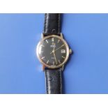 A gent's 9ct gold Omega De Ville Seamaster Automatic wrist watch with date indicator, black dial