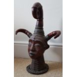 An African Ejagham head crest in clay, hide and rattan. 18" high. Bought in the Woolley & Wallis