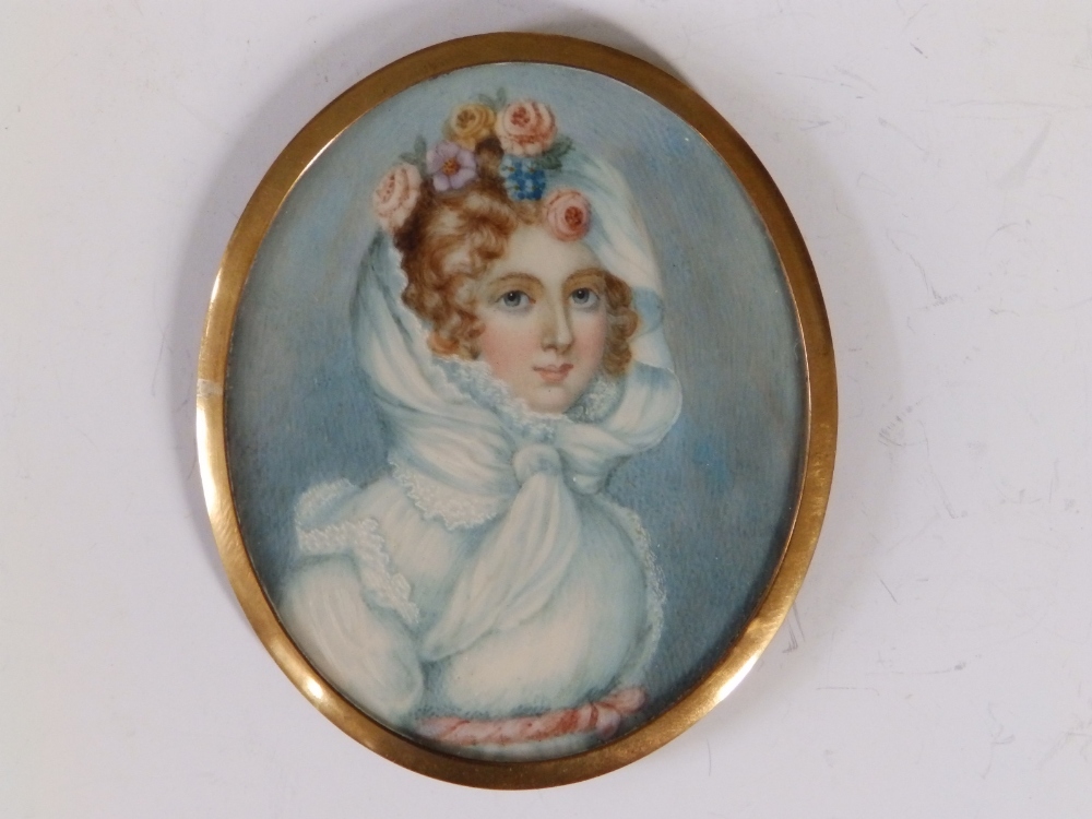 A late 19thC oval watercolour miniature - Portrait of young lady with pale blue scarf and flowers in