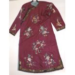 A late 19thC Chinese fully embroidered ruby silk robe, overall length 48".