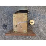 An incomplete brass clock movement with finned pillars and bell striking, the backplate 6.5" x 4.